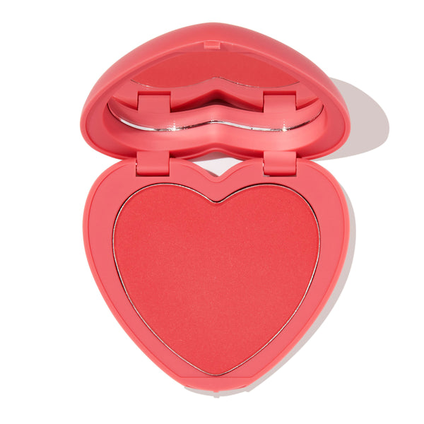 4ever Yours pressed powder blush opens to reveal a heart-shaped pink-coral pan inside a pink compact with built-in mirror on a white background; ColourPop Pressed Powder Blush offering soft, buildable cheek color.