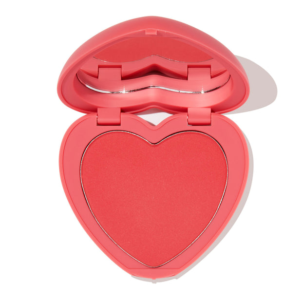 4ever Yours pressed powder blush opens to reveal a heart-shaped pink-coral pan inside a pink compact with built-in mirror on a white background; ColourPop Pressed Powder Blush offering soft, buildable cheek color.