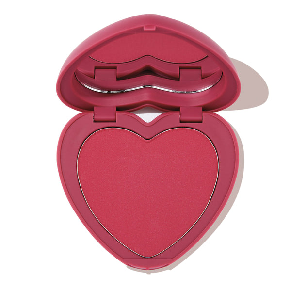 Babycakes ColourPop Pressed Powder Blush shown open, revealing a heart-shaped rosy pink pan in a matching pink compact with a lip-shaped mirror detail, photographed on a white background.