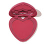 Babycakes ColourPop Pressed Powder Blush shown open, revealing a heart-shaped rosy pink pan in a matching pink compact with a lip-shaped mirror detail, photographed on a white background.
