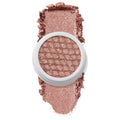 Aster ColourPop Super Shock Shadow sits open in a white pot, honeycomb-pressed pan glistening in a rose-gold metallic shimmer, with crushed pigment swatched above and below on a clean white background.