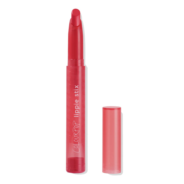 Jam Sesh ColourPop Lippie Stix in bright cherry red, twist-up slim lipstick with angled tip, shown uncapped with a translucent red tube and matching cap set to the side on a white background.