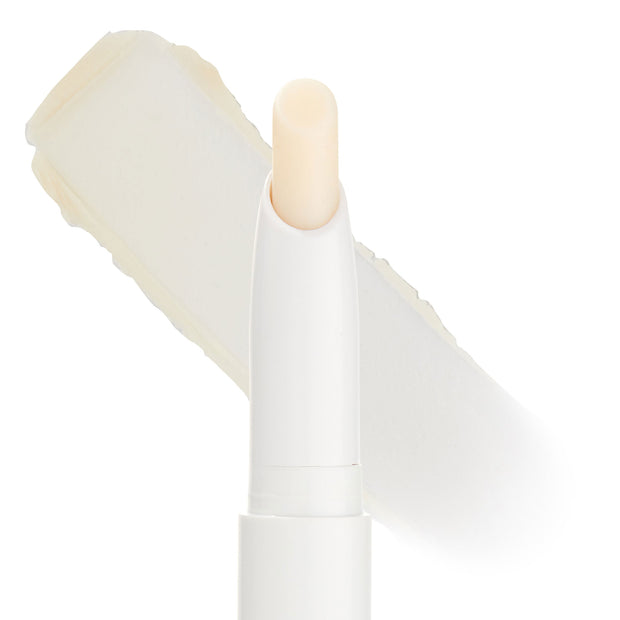 ColourPop Lippie Stix Primer shown uncapped, revealing a creamy translucent lip primer in a slim white twist-up tube, with an off-white product swatch behind on a clean white background.