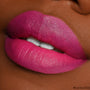 Fuchsia lips lined and filled with ColourPop Lippie Pencil Heart On, showcasing rich matte color, crisp edges, and full coverage in an extreme close-up on deep skin.