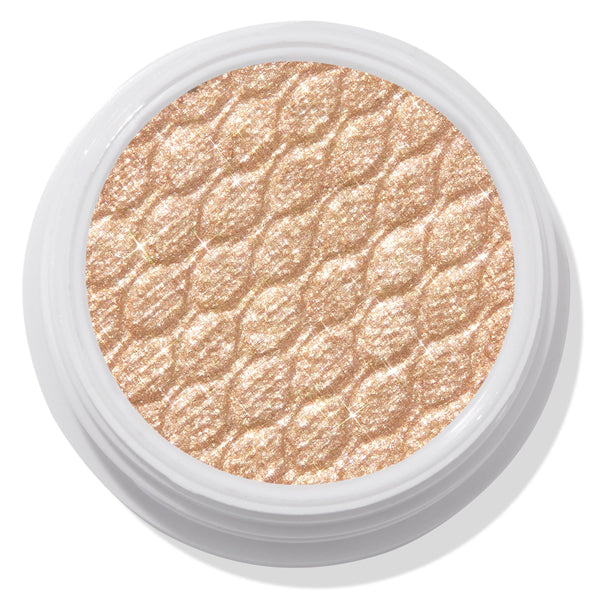 ColourPop Super Shock Shadow Flower Child displaying a shimmery champagne-gold eyeshadow pan with a quilted sparkle texture, set in a white round pot on a light backdrop.