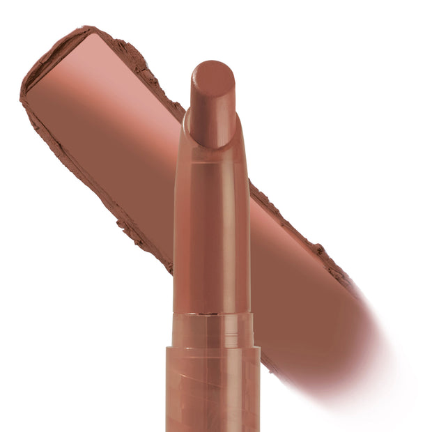 ColourPop Lippie Stix In the Nude displays a slim twist-up lip crayon with the creamy tip exposed, laying a warm rosy-brown nude swatch across a white backdrop to show color payoff and satin texture.