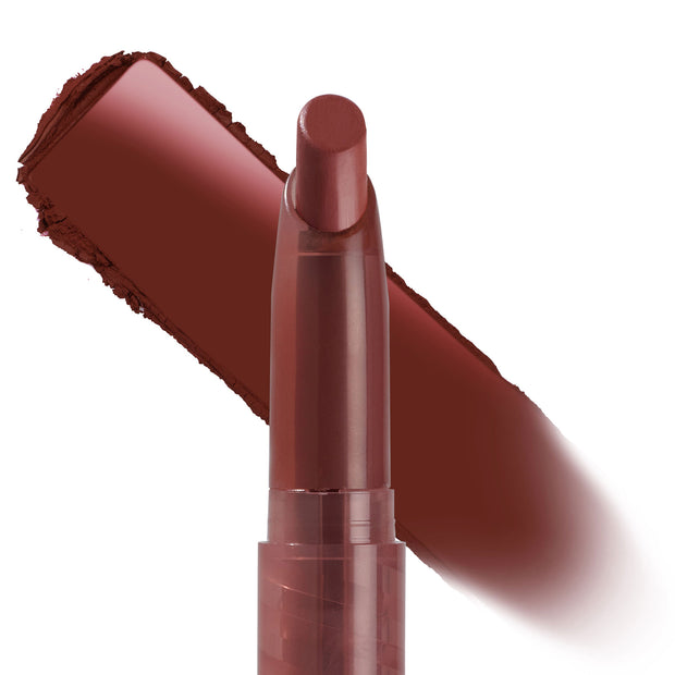 Hot in Here ColourPop Lippie Stix standing uncapped with the rounded bullet forward, a wide brick red-brown swatch swept behind it to show rich, creamy payoff against a clean white background.