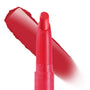 ColourPop Lippie Stix Hot in Here standing upright with a bold red swatch brushed diagonally behind, a slim twist-up lip crayon in vivid warm red housed in a matching tube on a white background, highlighting its creamy full-coverage finish.