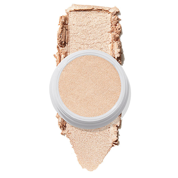 ColourPop Super Shock Highlighter in Lunch Money displaying a creamy champagne‑pearl pan atop a thick swatch of luminous shimmer on white, emphasizing its soft, buildable glow for face and cheek highlighting.