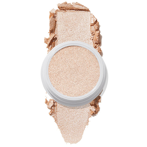 ColourPop Super Shock Highlighter Flexitarian swatched in a reflective icy champagne tone, the creamy formula pressed in a white pot with a bold swipe above and below on a white background, showing high-impact shimmer.