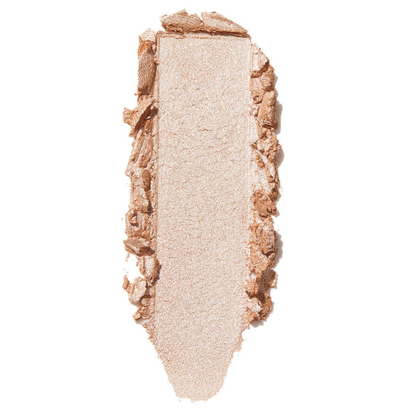 ColourPop Flexitarian Super Shock Highlighter swatch glinting champagne-beige, a smooth vertical swipe with softly crumbled edges on a white background, showcasing its creamy, ultra-reflective metallic glow.