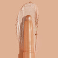 Honey BB ColourPop Shadow Stix crayon swipes a warm honey-gold metallic eyeshadow, with a creamy reflective swatch and fine sparkle catching light against a nude peach background.