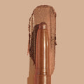 Quokka ColourPop Shadow Stix glides a warm copper-bronze metallic swatch, the creamy eyeshadow stick with a rounded tip centered over its shimmery smear on a nude background.