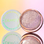 ColourPop Jelly Much Shadow Boo-Kay shown open, a sparkling lavender-lilac gel eyeshadow in a clear round pot, white lid with neon green logo beside it, reflected on a mirror with a pink-to-yellow gradient background.