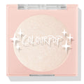 Cold One highlighter compact showcasing a shimmering icy pearl pan behind a clear lid with white sparkle icons and ColourPop logo, closed in a blush‑pink square case on a white background; ColourPop Pressed Powder Highlighter.