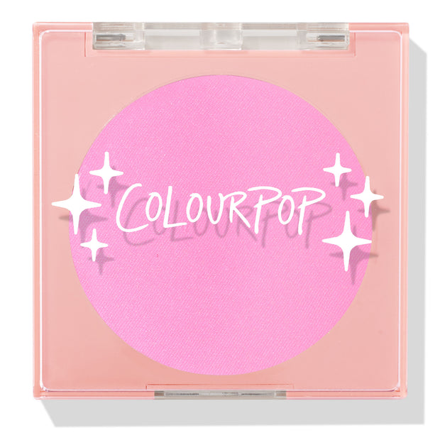 ColourPop Pressed Powder Blush in Flamingo shows a vibrant hot pink pan inside a square peach compact with a clear lid and white sparkles logo, closed and travel-friendly on a light background.
