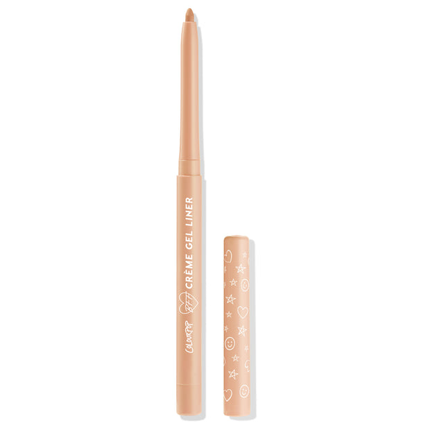 ColourPop Crème Gel Liner Honeydude shown uncapped, twist-up nude beige eyeliner with rounded tip standing upright on a white background, its peach cap set beside it with white heart, star, and smiley doodles.