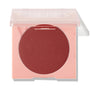 Icing on Top ColourPop Pressed Powder Blush, a deep berry matte pressed powder, sits in a peach square compact with a translucent lid half closed against a white studio background.