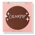 Latte Run ColourPop Pressed Powder Blush sits closed in a square pink compact with a clear lid, revealing a deep latte-brown pan with the ColourPop logo and star graphics, studio shot on a white background.