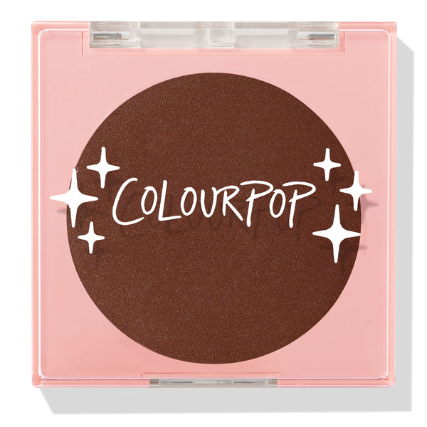 Latte Run ColourPop Pressed Powder Blush sits closed in a square pink compact with a clear lid, revealing a deep latte-brown pan with the ColourPop logo and star graphics, studio shot on a white background.