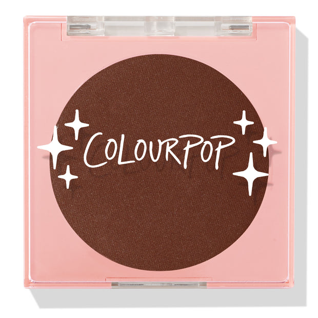 Latte Run ColourPop Pressed Powder Blush sits closed in a square pink compact with a clear lid, revealing a deep latte-brown pan with the ColourPop logo and star graphics, studio shot on a white background.