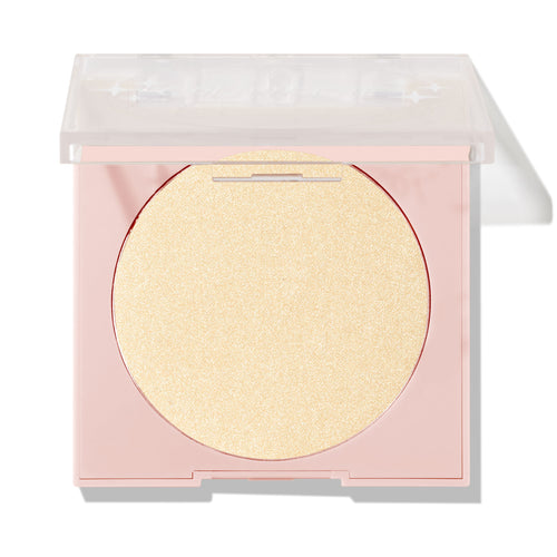 Minted pressed powder highlighter sitting half-open, displaying a large circular pan of pale gold shimmer in a blush-pink compact with a clear lid; ColourPop Pressed Powder Highlighter shade Minted for a luminous glow.