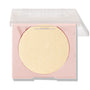 Minted pressed powder highlighter sitting half-open, displaying a large circular pan of pale gold shimmer in a blush-pink compact with a clear lid; ColourPop Pressed Powder Highlighter shade Minted for a luminous glow.