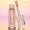 Bliss ColourPop Chrome Liquid Shadow opened, the shimmery multichrome wand resting on a clear cap with star accents, showing pink‑to‑gold‑lilac shift in a clear tube labeled ColourPop, set on a reflective peach‑to‑pink gradient backdrop with a NEW badge.