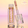 Bliss ColourPop Chrome Liquid Shadow opened, the shimmery multichrome wand resting on a clear cap with star accents, showing pink‑to‑gold‑lilac shift in a clear tube labeled ColourPop, set on a reflective peach‑to‑pink gradient backdrop with a NEW badge.