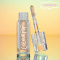 ColourPop Chrome Liquid Shadow in Sweetzer Ave stands open as the doe-foot applicator reveals a multi-chrome gold-peach sheen, the clear tube with white ColourPop logo reflecting against a mint-to-peach gradient background with a “MUST-HAVE” badge.