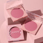 ColourPop New to U pressed powder blush compact opens to reveal a soft rosy‑mauve pan, flanked by a second open compact and a boxed unit, styled on pastel pink blocks; clear lids and star accents brand the ColourPop Pressed Powder Blush.