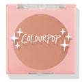 ColourPop Pressed Powder Blush Out & About shown closed, a soft peach blush in a pink square compact with a clear lid, white star graphics, and ColourPop logo, photographed on a white studio background.