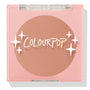 ColourPop Pressed Powder Blush Out & About shown closed, a soft peach blush in a pink square compact with a clear lid, white star graphics, and ColourPop logo, photographed on a white studio background.