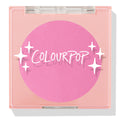 Pitaya ColourPop Pressed Powder Blush compact displays a vivid hot‑pink pan through a clear lid, housed in a peach square case with white sparkle graphics, closed to showcase the cool‑toned fuchsia shade for cheeks.