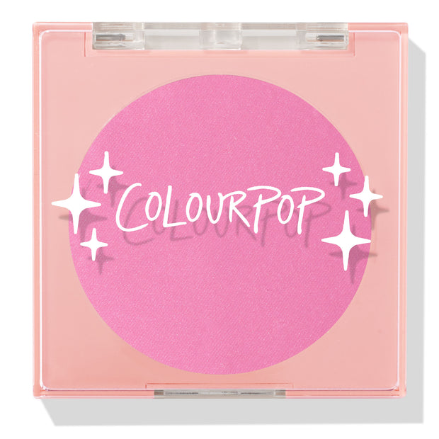 Pitaya ColourPop Pressed Powder Blush compact displays a vivid hot‑pink pan through a clear lid, housed in a peach square case with white sparkle graphics, closed to showcase the cool‑toned fuchsia shade for cheeks.