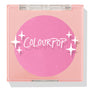 Pitaya ColourPop Pressed Powder Blush compact displays a vivid hot‑pink pan through a clear lid, housed in a peach square case with white sparkle graphics, closed to showcase the cool‑toned fuchsia shade for cheeks.