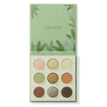 ColourPop Shadow Palette Sage The Day lies open, displaying a 3x3 grid of sage greens, golds, peach, brown, and a mint‑lilac duochrome in matte and shimmer finishes, set in a light green leaf-print compact.