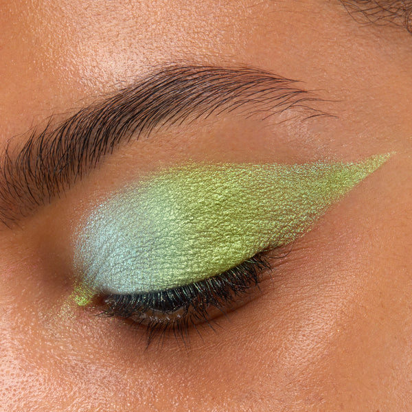 Closed eye showcases See U Later Chrome Liquid Shadow, a ColourPop Chrome Liquid Shadow, blended from icy mint to lime green with a metallic shift and sharp winged edge, highlighting lashes and brow area in a tight close-up.