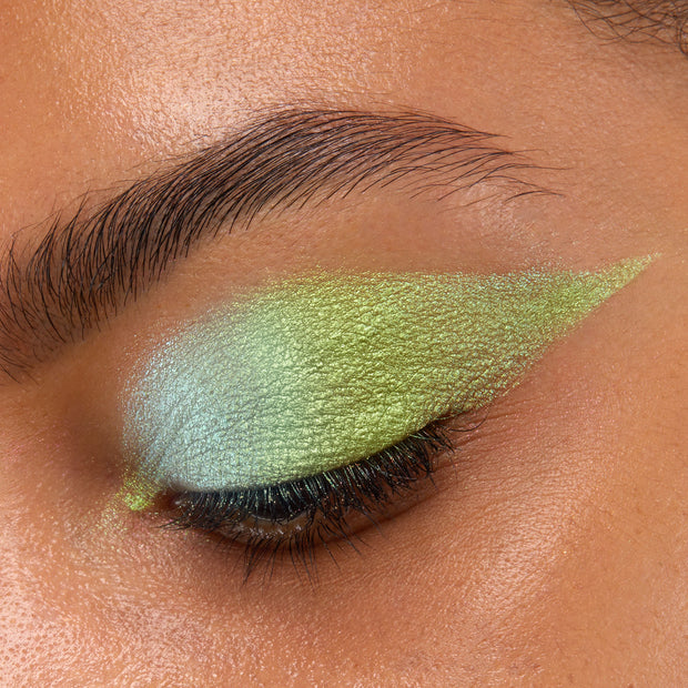 Closed eye showcases See U Later Chrome Liquid Shadow, a ColourPop Chrome Liquid Shadow, blended from icy mint to lime green with a metallic shift and sharp winged edge, highlighting lashes and brow area in a tight close-up.
