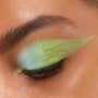 Closed eye showcases See U Later Chrome Liquid Shadow, a ColourPop Chrome Liquid Shadow, blended from icy mint to lime green with a metallic shift and sharp winged edge, highlighting lashes and brow area in a tight close-up.