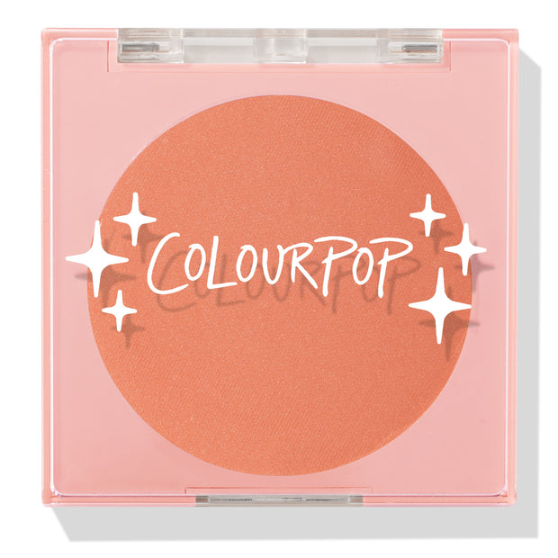 ColourPop Pressed Powder Blush Shortbread shows a warm peach pan sitting in a square pink compact, closed under a clear lid printed with the ColourPop logo and star accents, photographed in clean studio lighting on a white background.
