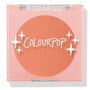 ColourPop Pressed Powder Blush Shortbread shows a warm peach pan sitting in a square pink compact, closed under a clear lid printed with the ColourPop logo and star accents, photographed in clean studio lighting on a white background.