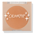 ColourPop Pressed Powder Bronzer in Silver Strand Beach, a warm tan matte shade, shown closed in a square clear compact with white ColourPop logo and star accents on the lid, displaying the full round pan in a sleek beige case.