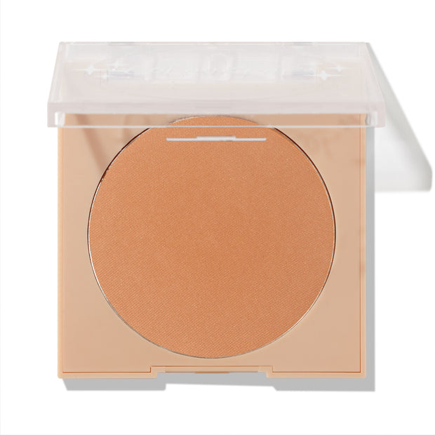 ColourPop Pressed Powder Bronzer in Silver Strand Beach, a warm tan matte shade, rests in a nude square compact with a clear lid flipped halfway open, revealing the round pan against a clean white studio background.