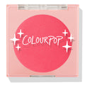 Staycation ColourPop Pressed Powder Blush compact, closed, showing a vivid coral-pink round pan under a clear square lid with white sparkle graphics and ColourPop logo, shot on a white background with a soft shadow.