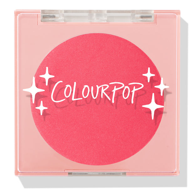 Staycation ColourPop Pressed Powder Blush compact, closed, showing a vivid coral-pink round pan under a clear square lid with white sparkle graphics and ColourPop logo, shot on a white background with a soft shadow.