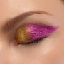 Closed eyelid wearing Supernova ColourPop Chrome Liquid Shadow, shifting metallic gold to fuchsia in a bold winged cat-eye, showing smooth chrome payoff and high-shine finish in a tight beauty close-up.