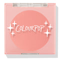 Swirled ColourPop Pressed Powder Blush compact closed, showcasing a warm peach‑coral matte pan beneath a clear pink lid with white starburst logo, square plastic case centered on a white background.