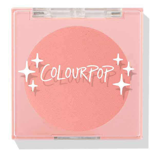 Swirled ColourPop Pressed Powder Blush compact closed, showcasing a warm peach‑coral matte pan beneath a clear pink lid with white starburst logo, square plastic case centered on a white background.