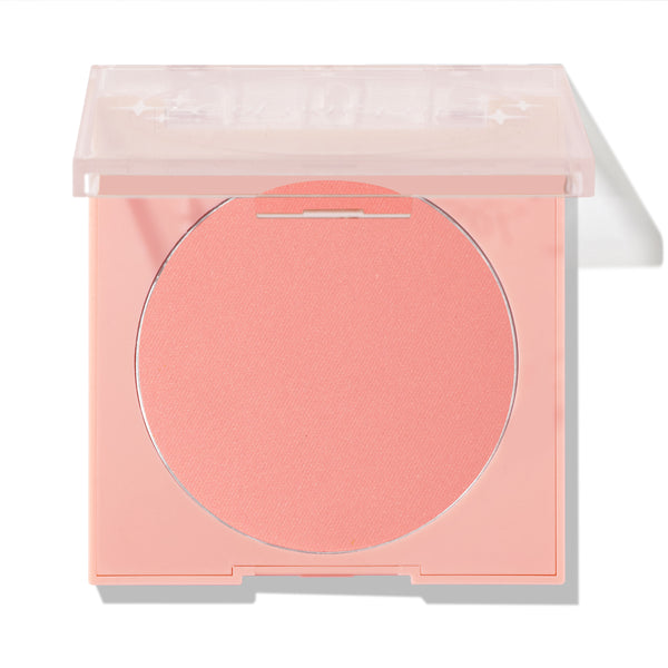 Swirled ColourPop Pressed Powder Blush shown half-open, a soft peachy‑pink pan in a pale pink square compact with a translucent lid, photographed on a white background for product display.